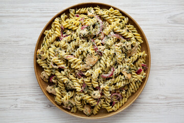 Homemade Creamy Lemon Butter Chicken Pasta on a Plate on a white wooden background, top view. Flat lay.