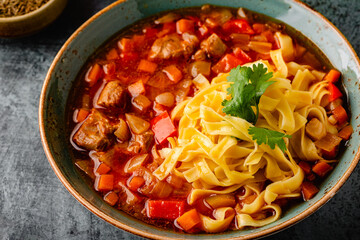 Lagman soup with lamb, homemade noodles and vegetables.
