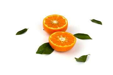 An orange fruit, orange slices, and orange leaves are isolated on a white background.