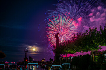 People watching beautiful fireworks at Constance lake night festival photographed from the harbor...