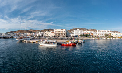 Fototapeta na wymiar Greece Tinos island Hora Cyclades. View from ship of building cafe port sea blue sky summer vacation