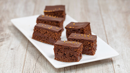 Fototapeta na wymiar Chocolate brownies on wooden table, homemade bakery and dessert