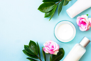 Natural cosmetic products. Cream, serum, tonic with green leaves and flowers. Skin care concept.