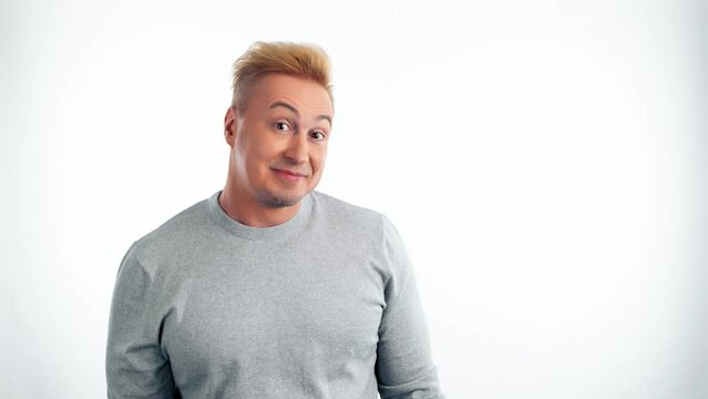 Comical funky man making fun silly facial expressions, fooling around. Caricature humor emotion and excited comic guy for good mood and positive feeling in studio isolated on white background