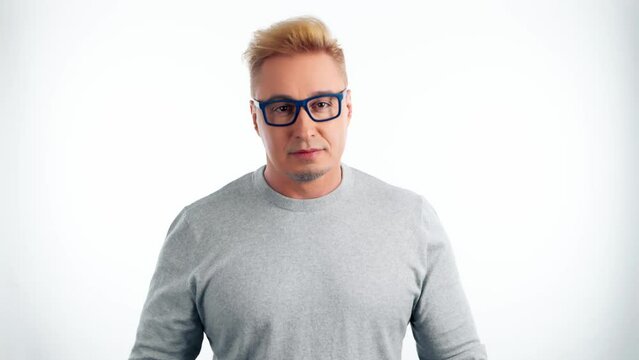 Positive businessman with eyesight and myopia problems, throwing away eyeglasses after vision laser treatment. Smiling guy in glasses for improve health, checking eye diagnose, healing on white