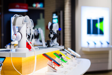 interior of a modern  electronic shop. table with a bunch of electronic devices on it
