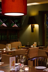 interior of restaurant / a restaurant with tables and chairs and a red lamp hanging from the ceiling