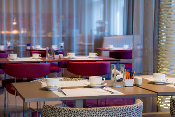interior of restaurant /  a restaurant with tables, chairs, and a large window