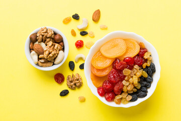 healthy snack: mixed nuts and dried fruits in bowl on table background, almond, pineapple, cranberry, cherry, apricot, cashew