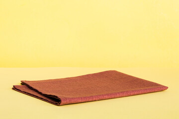 top view with red empty kitchen napkin isolated on table background. Folded cloth for mockup with copy space, Flat lay. Minimal style