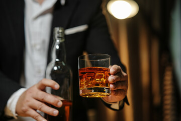 Barman pouring whiskey whiskey glass celebrate whiskey on a friendly party in  restaurant