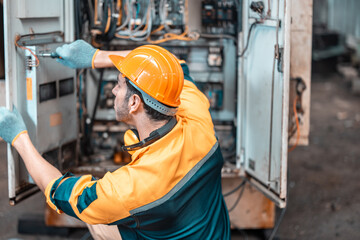 Electrical technician tests wiring, polarity, grounding, voltages and performs electrical maintenance using hand tools that involve clamp meter, screwdriver, and cutter. The foreman's routine tasks.