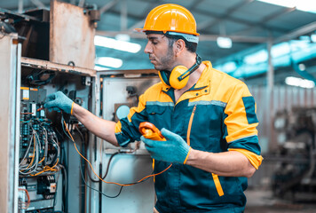 Electrical technician tests wiring, polarity, grounding, voltages and performs electrical maintenance using hand tools that involve clamp meter, screwdriver, and cutter. The foreman's routine tasks.