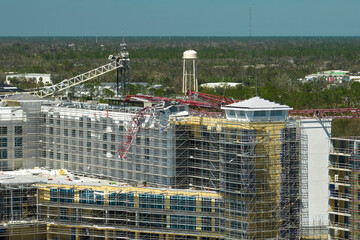Aerial view of ruined by hurricane Ian construction crane on high apartment building site in Port Charlotte, USA