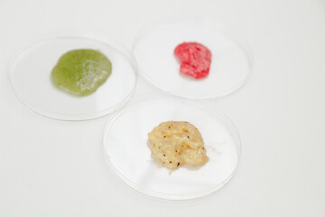 Three Petri Dishes with Color Cosmetics Scrub on white Background, Laboratory Test, flat lay.