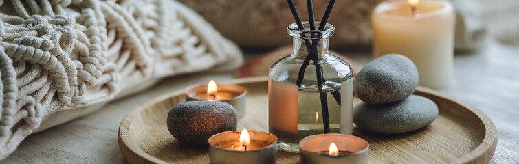 Apartment natural aroma diffusor ocean breeze fragrance. Banner. Burning candles on bamboo tray,...