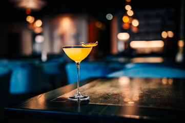 alcohol cocktail in a glass stands on a table in a bar or restaurant