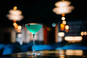 alcohol cocktail in a glass stands on a table in a bar or restaurant