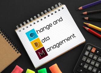 CDM - Change and Data Management acronym on notepad, business concept background