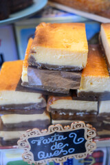 Fresh baked pastries and sweets on display in artisan Spanish confectionery shop, cheese cake