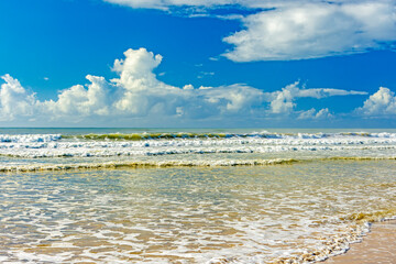 Waves and sea foam in the vividly colored sea, on a sunny summer day at Sargi beach in Serra...