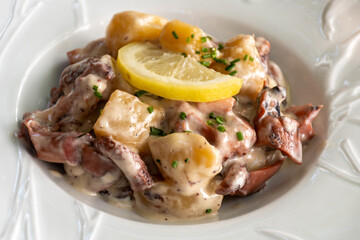Tastes od Camargue, Provence, hot dish salad with boiled octopus, potatoes and white sauce, served...