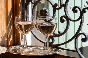 French cold rose dry wine from Provence in glasses served on window frame with wrought iron grille...
