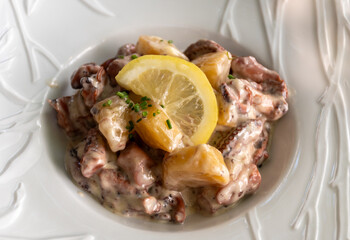 Tastes od Camargue, Provence, hot dish salad with boiled octopus, potatoes and white sauce, served in French restaurant