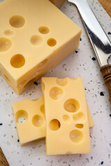 Cheese collection, french hard cheese with holes emmentaler close up
