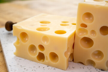 Cheese collection, french hard cheese with holes emmentaler close up