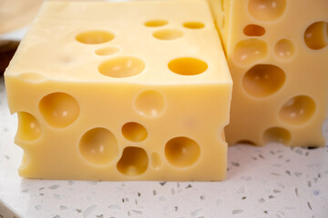 Cheese collection, french hard cheese with holes emmentaler close up