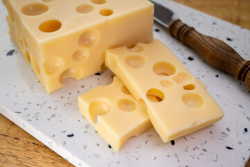 Cheese collection, french hard cheese with holes emmentaler close up