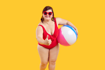 Happy plus size woman enjoys summer holiday and recommends good resort. Fat lady in red swimsuit...