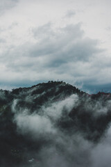 Beautiful view of mountains in the fog - scenic view of Shimla hills on a rainy day - Shimla hill station