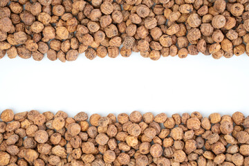 Top view of a of tigernuts on a white background with copy space in the middle