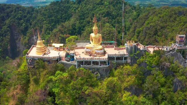 Aerial view Tiger Cave Temple, Buddha on the top Mountain with blue sky of Wat Tham Seua, Krabi,Thailand. Aerial view 4K.