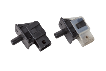 car connector or trailer for closing an electrical circuit that a mechanic holds in gloves during repairs.