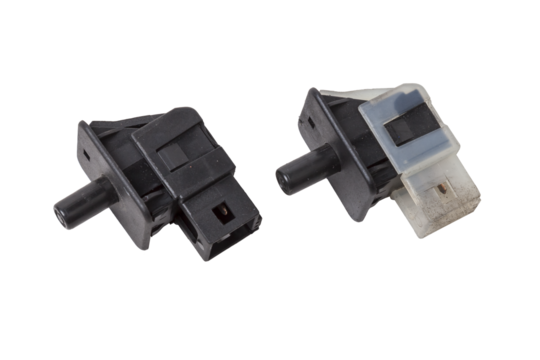 car connector or trailer for closing an electrical circuit that a mechanic holds in gloves during repairs.