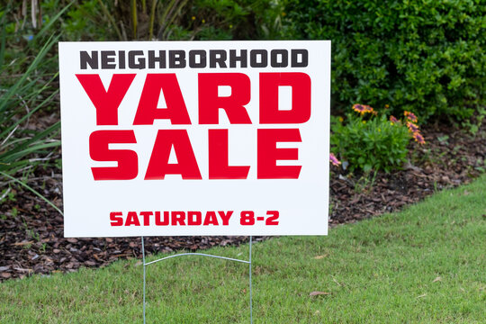 Neighborhood Yard Sale Sign placed in yard