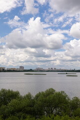 Fototapeta premium Landscape, view of the lake and the shore, green trees and water surface