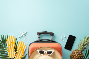 Beach retreat concept. Top view of suitcase, miniature plane model, beach gear, glasses, hat,...