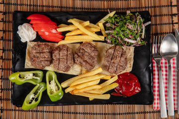 Turkish meatball traditional kofte. Spicy meatballs Kebab or Kebap. Turkish meatballs with fresh green peppers and pickles.