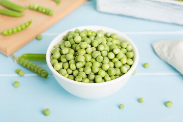 Composition with fresh green peas on wooden table