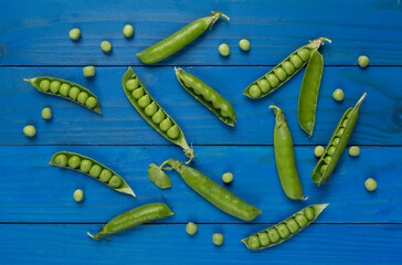 Composition with fresh green peas on wooden background, top view