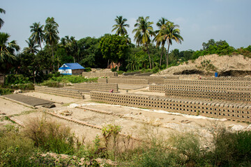 5th June, 2023, Burul, West Bengal, India: Blocks of hand made traditional bricks stack under the sun to dry up in a brick factory.