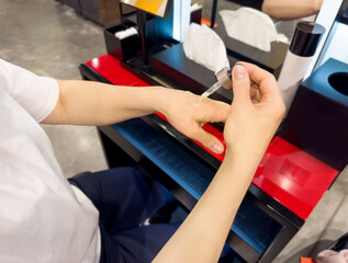 buying make up at cosmetics section in store. choosing cosmetics, perfumes, creams and shampoos, Using tester.