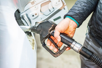 gas station putting gasoline into car oil price - obrazy, fototapety, plakaty