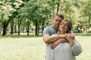 portrait of a couple in love a man and a pregnant woman are hugging, waiting for a new addition to the happy family
