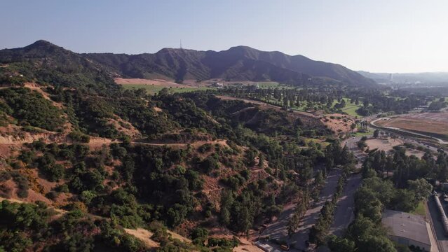 Drone and aerial view of mountain landscape and forests near Griffith Park and Hollywood hills outside Los Angeles, California
