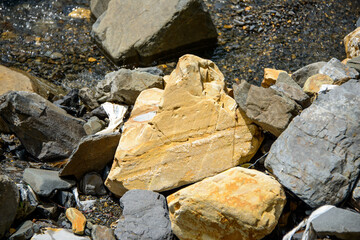 Water flowing over river rocks near mountains in Nathia Gali, Abbottabad, Pakistan.